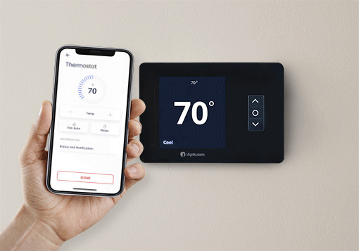 Woman using iApartments Smart Home App to control smart thermostat